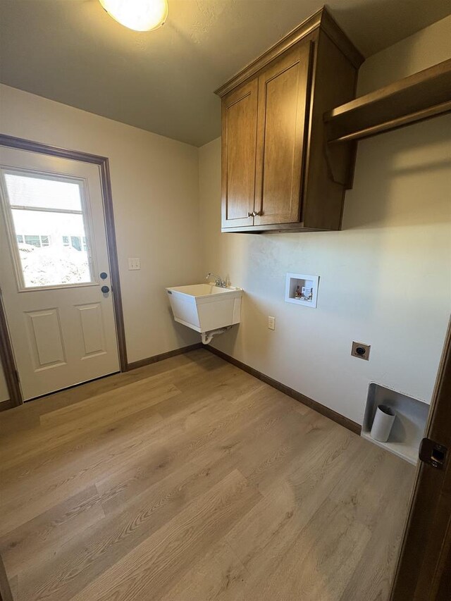 1354 Shelby Ln, De Pere, WI 54115 - laundry room with hookup for a washing machine, a sink, hookup for an electric dryer, cabinet space, and light wood finished floors