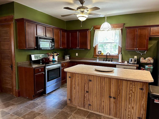 kitchen with ceiling fan, a kitchen island, black microwave, stainless steel electric range oven, and a sink