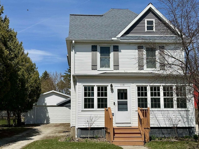 view of front of property featuring a garage and an outbuilding