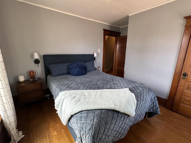 bedroom featuring ornamental molding and hardwood / wood-style floors