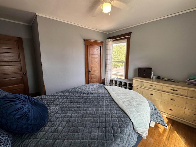 bedroom featuring ceiling fan, ornamental molding, and light wood-style floors