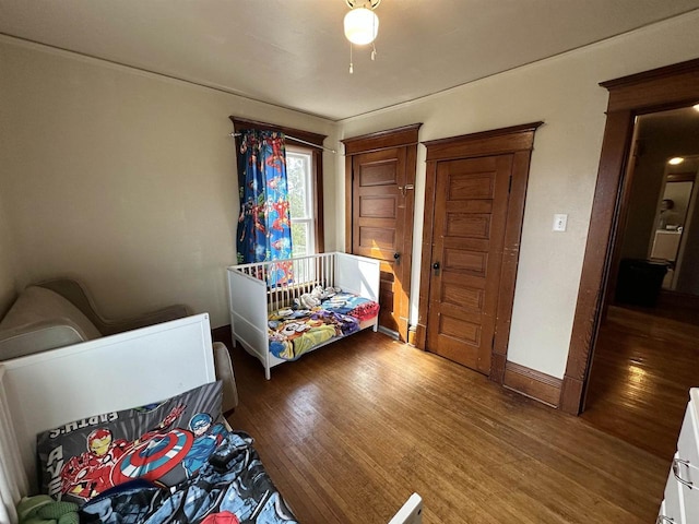 bedroom featuring baseboards and wood finished floors
