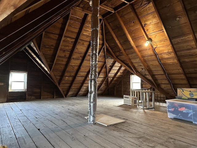 unfinished attic featuring an upstairs landing