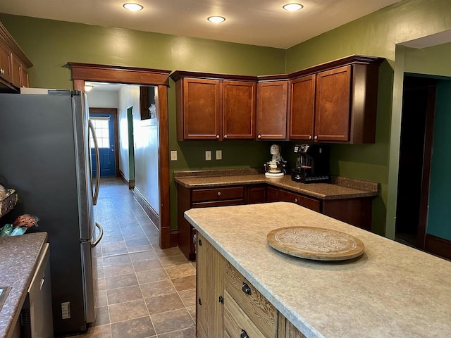 kitchen with freestanding refrigerator, recessed lighting, and baseboards