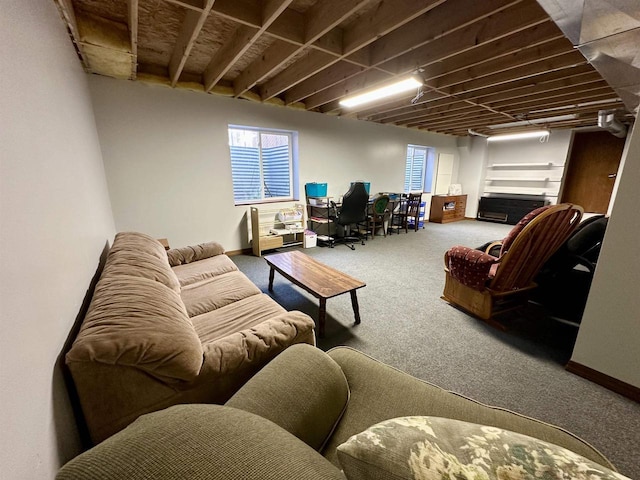 carpeted living room featuring baseboards and a wealth of natural light