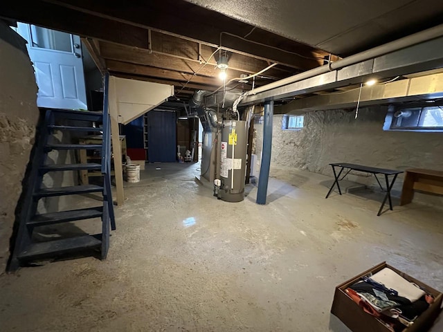 unfinished basement with gas water heater and stairs