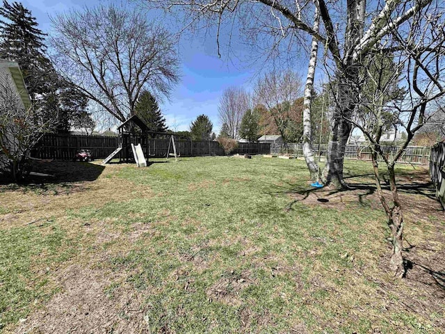view of yard featuring a playground and a fenced backyard
