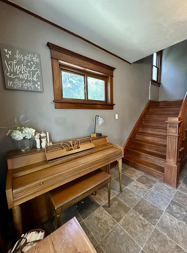 interior space with crown molding and baseboards