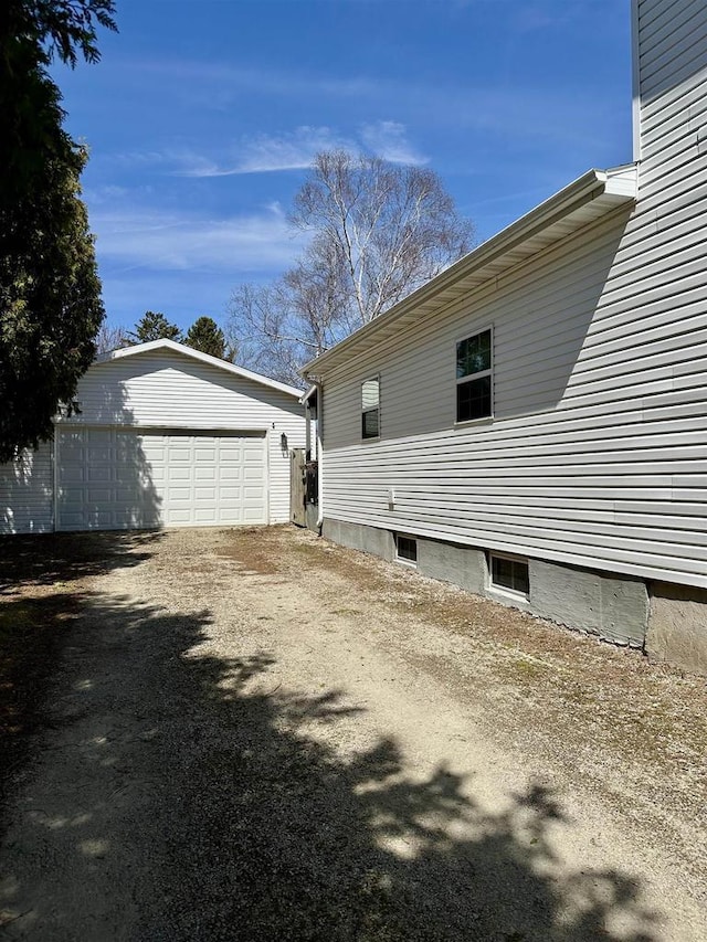 view of home's exterior featuring a garage and an outbuilding