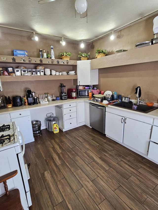 kitchen featuring appliances with stainless steel finishes, dark wood-type flooring, white cabinetry, and light countertops