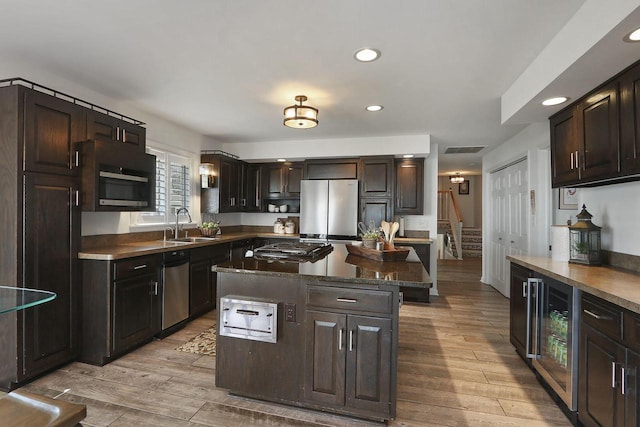 kitchen with recessed lighting, beverage cooler, visible vents, a sink, and appliances with stainless steel finishes