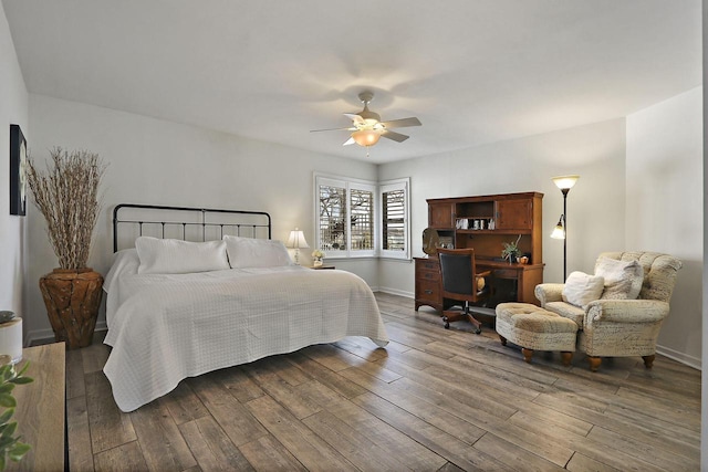 bedroom featuring ceiling fan, baseboards, and hardwood / wood-style floors