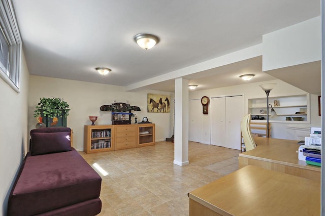 living area featuring baseboards and light tile patterned floors