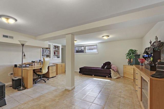 office area with light tile patterned flooring, visible vents, and baseboards
