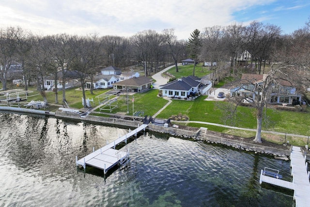 view of dock with a yard, a residential view, and a water view