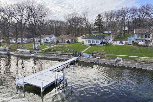 dock area with a yard, a residential view, and a water view