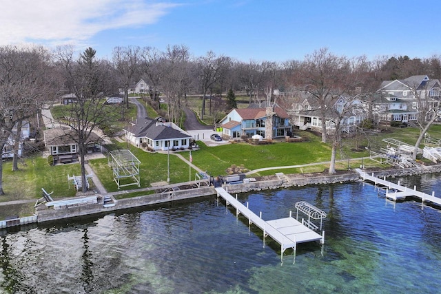 dock area with a lawn, a water view, and a residential view
