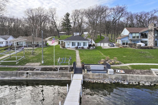 dock area with a lawn and a water view