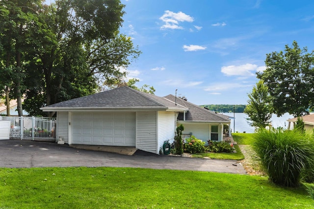 view of front of home with fence, a shingled roof, and a front lawn