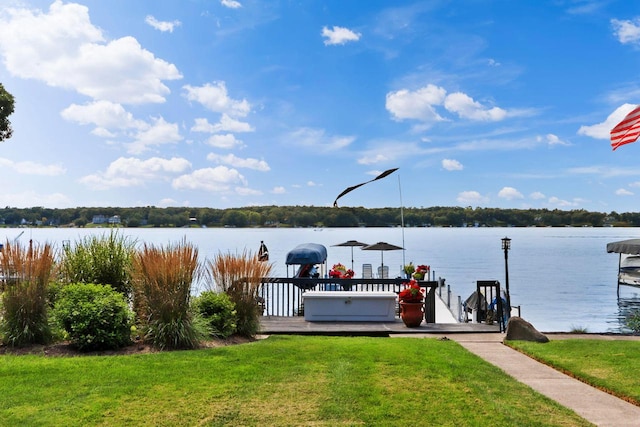 view of dock featuring a yard and a water view