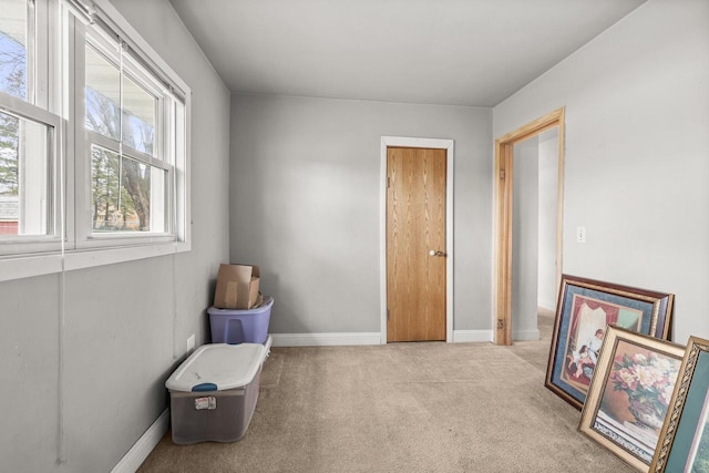 unfurnished room with carpet floors and baseboards