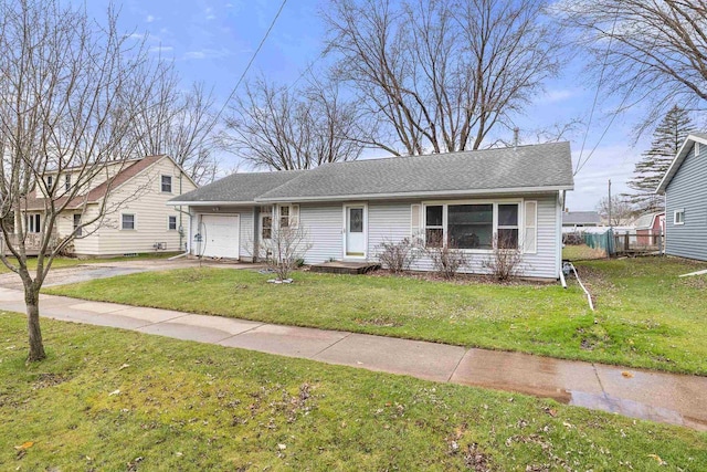 view of front of home featuring concrete driveway, a front lawn, and a garage