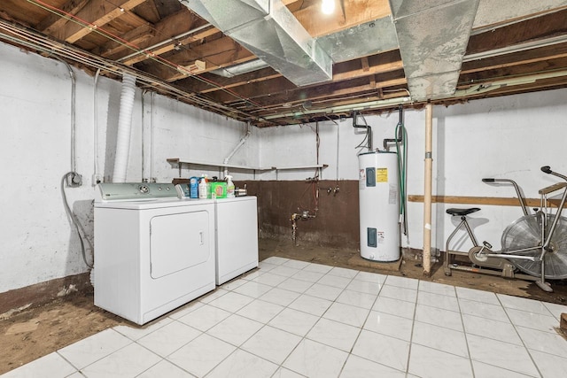 washroom with electric water heater, independent washer and dryer, and laundry area