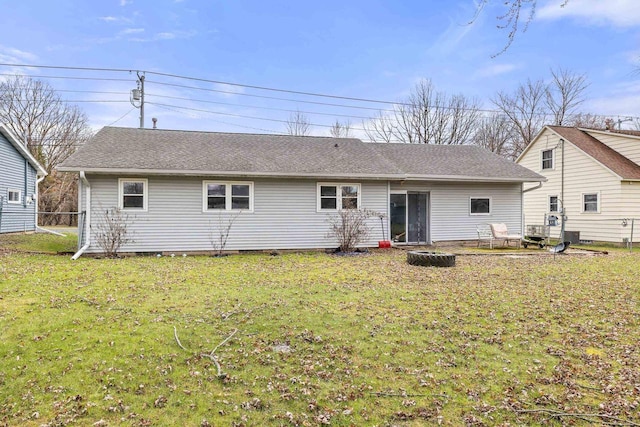 back of house with a lawn