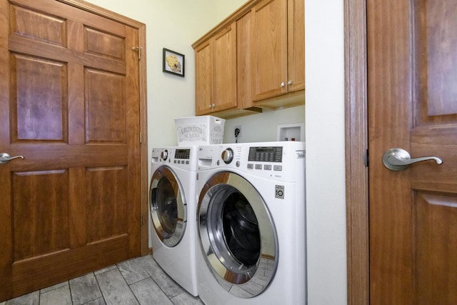 laundry room with washer and dryer and cabinet space