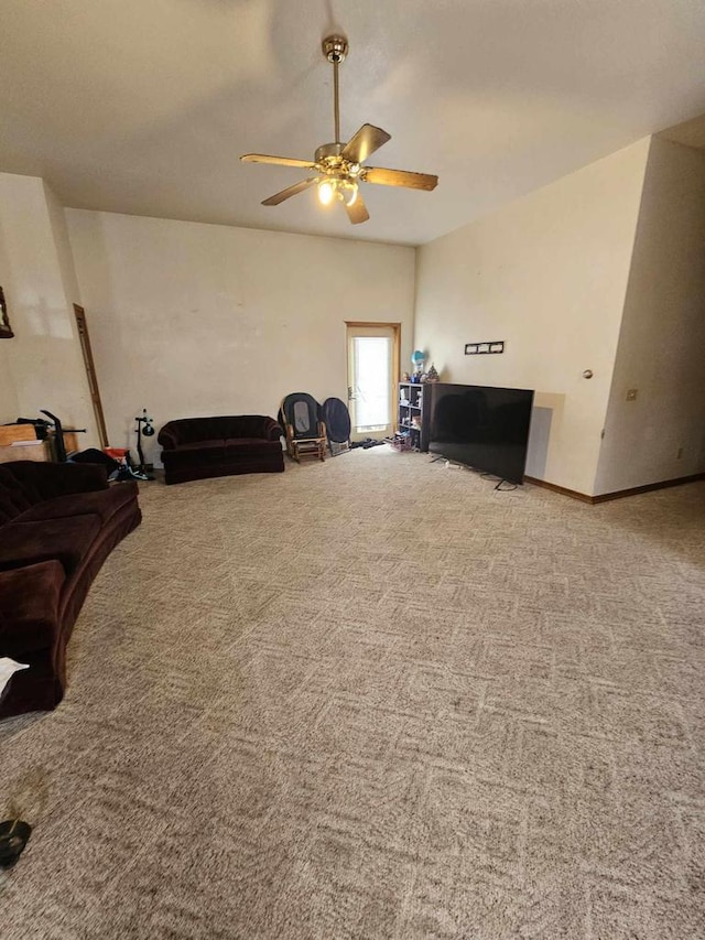 living room featuring ceiling fan and carpet