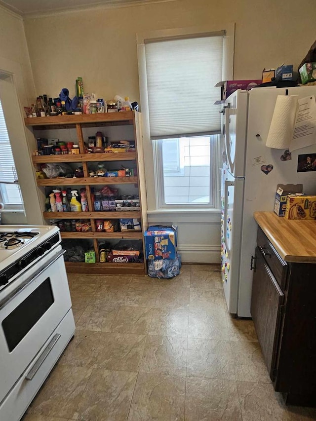 kitchen featuring ornamental molding and white appliances