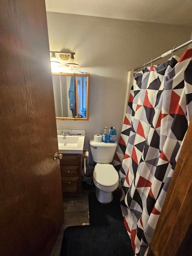 bathroom featuring vanity, a shower with shower curtain, and toilet