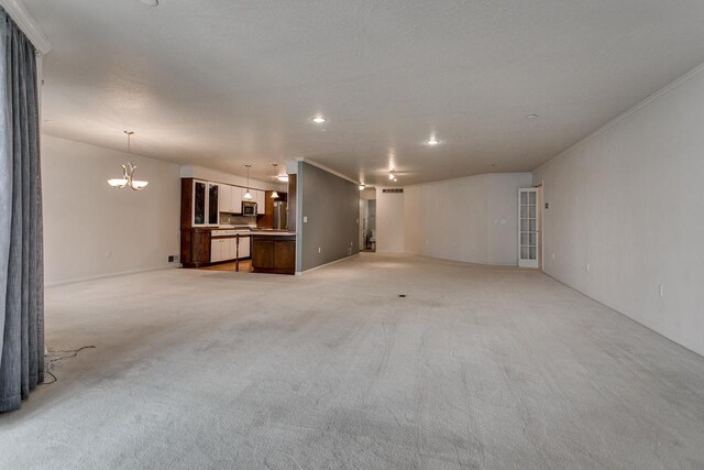 unfurnished living room featuring recessed lighting, a notable chandelier, ornamental molding, and light carpet