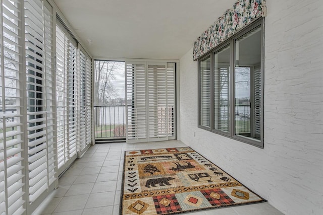 unfurnished sunroom featuring tile patterned flooring