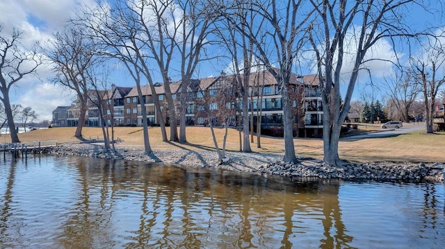 view of dock featuring a yard and a water view