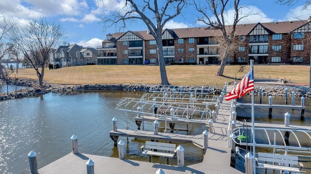 dock area featuring a lawn, a water view, and boat lift