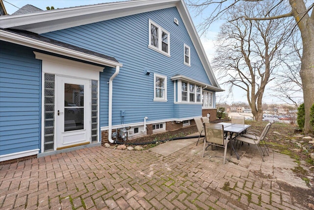 back of house featuring a patio area and outdoor dining space