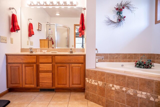 W3760 W Lemonweir Ct, Mauston, WI 53948 - bathroom with a bath, double vanity, a stall shower, visible vents, and tile patterned flooring