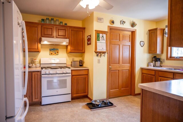 W3760 W Lemonweir Ct, Mauston, WI 53948 - kitchen featuring a ceiling fan, brown cabinets, under cabinet range hood, and white appliances