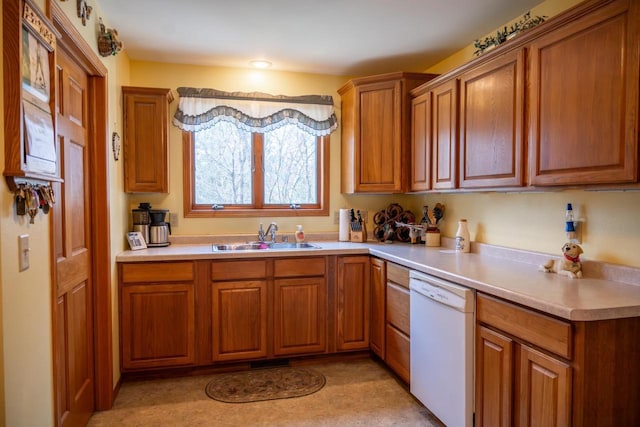 W3760 W Lemonweir Ct, Mauston, WI 53948 - kitchen with light countertops, dishwasher, brown cabinetry, and a sink