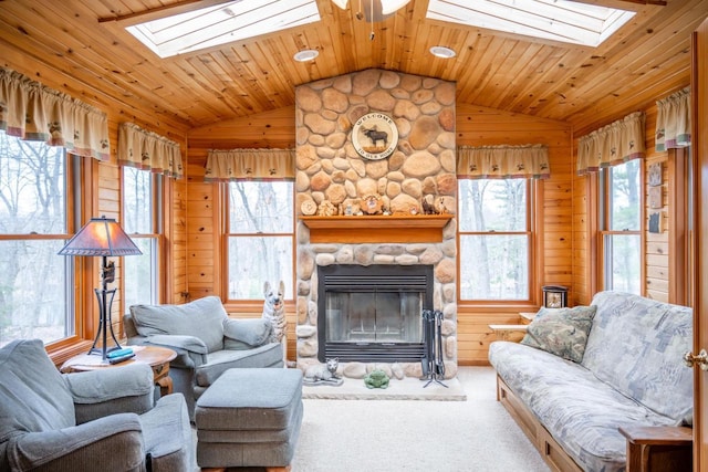 W3760 W Lemonweir Ct, Mauston, WI 53948 - living area featuring wooden walls, lofted ceiling with skylight, and a healthy amount of sunlight
