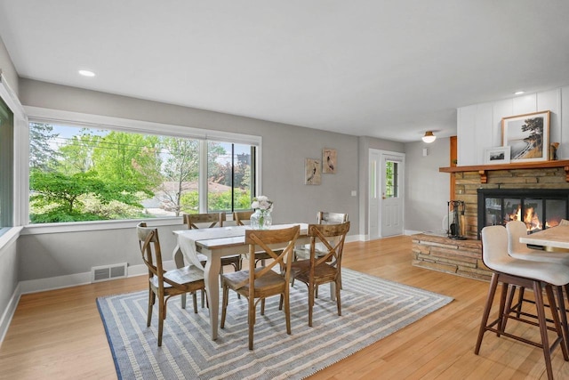 5308 Mckenna Rd, Monona, WI 53716 - dining space with a fireplace, light wood-style flooring, and baseboards