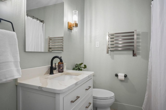 5308 Mckenna Rd, Monona, WI 53716 - bathroom with radiator heating unit, vanity, toilet, and a towel warmer