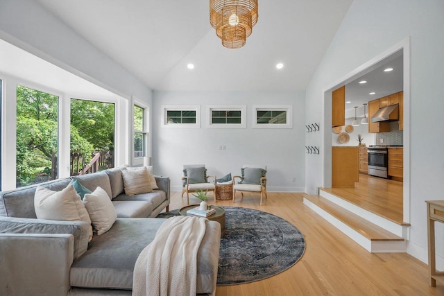 5308 Mckenna Rd, Monona, WI 53716 - living room with vaulted ceiling, light wood-type flooring, baseboards, and recessed lighting