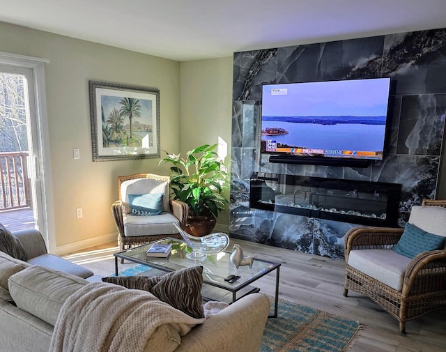 living room with a fireplace and wood finished floors