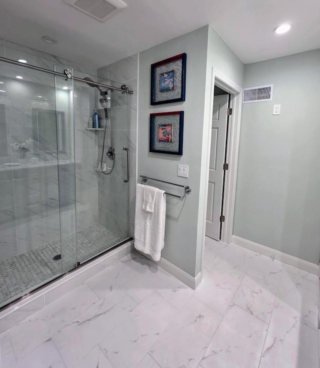 bathroom featuring visible vents, marble finish floor, baseboards, and a stall shower