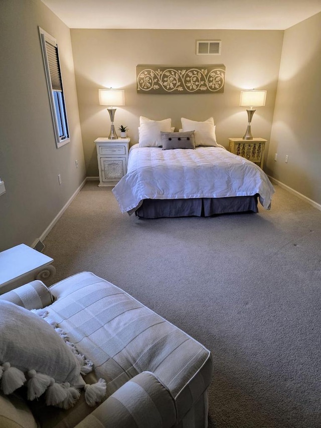 carpeted bedroom with baseboards and visible vents