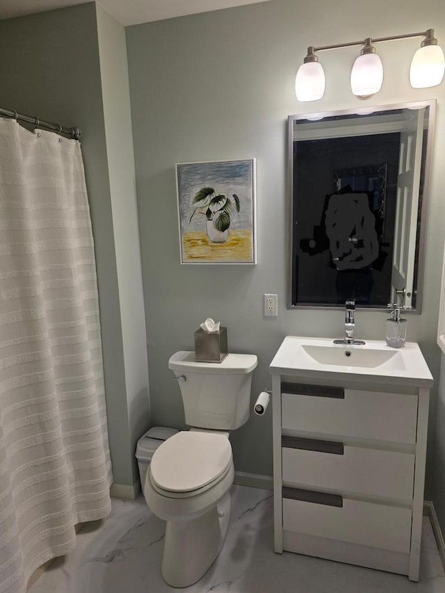 full bathroom with vanity, marble finish floor, baseboards, and toilet