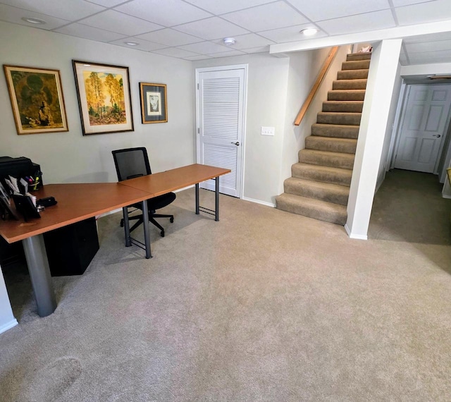 office featuring baseboards, carpet, and a drop ceiling