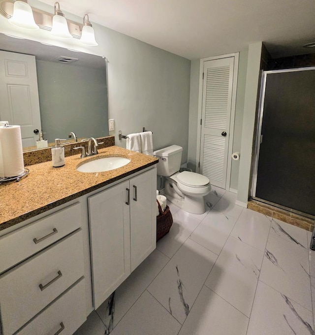 bathroom featuring marble finish floor, toilet, vanity, and a stall shower